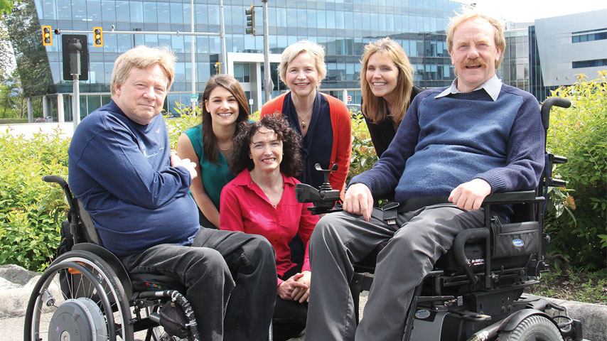 Group photo, with two people using wheelchairs.