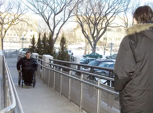 Rick wheels up ramp of Manitoba Legislature