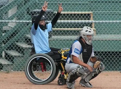 Trent Seymour playing fastball in his wheelchair