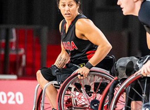 Two women playing wheelchair basketball
