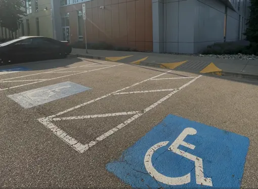 A parking lot with Accessible parking stalls for persons with disabilities.