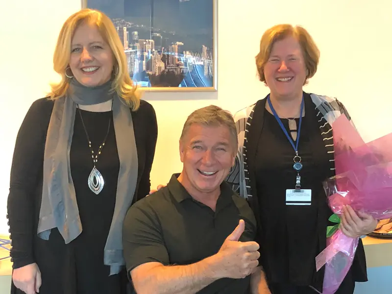 Rick Hansen accompanied with his wife and CEO Doramy Ehling smiling. 