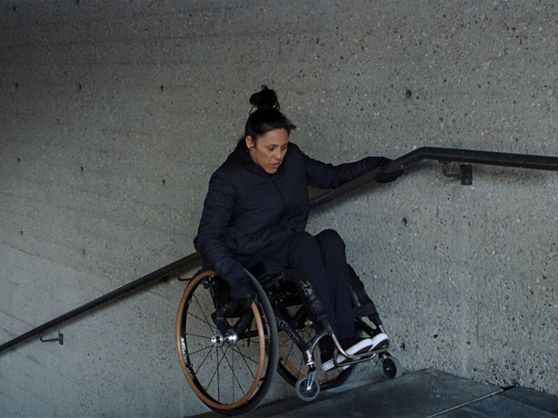 Lady on wheelchair climbing stairs