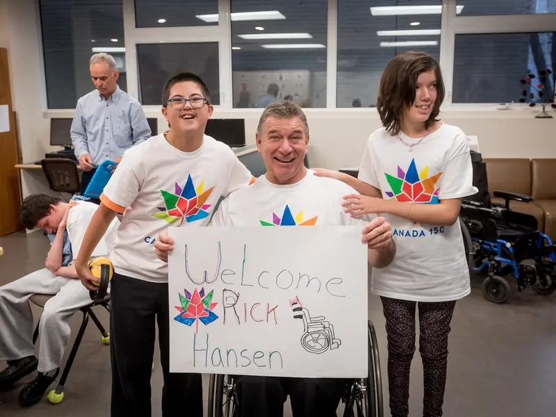 Rick Hansen and students at a school which received a Canada 150 Signature initiative Barrier buster grant