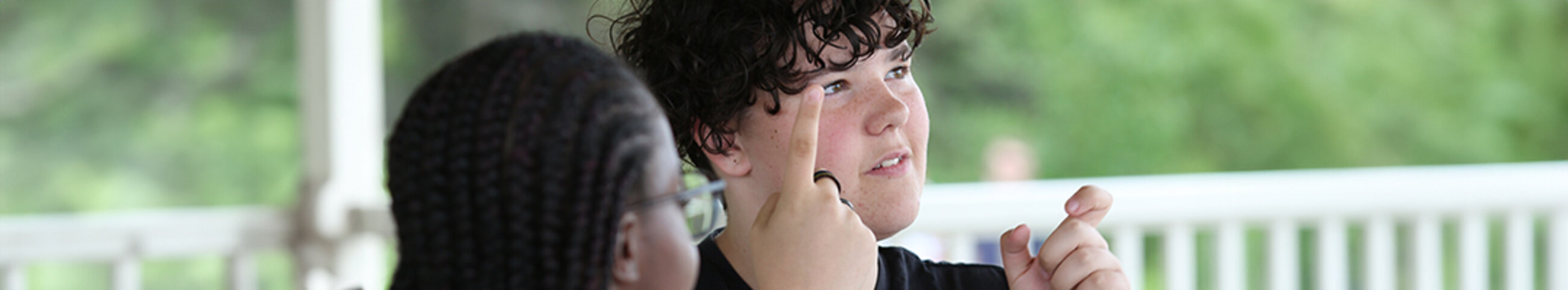 teenager communicating using sign language, outdoors