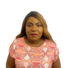 Laetitia Mfamobani, who has long brown hair and is wearing dark pink lipstick and eyeshadow. She is wearing a pink and peach shirt and is against a white background.